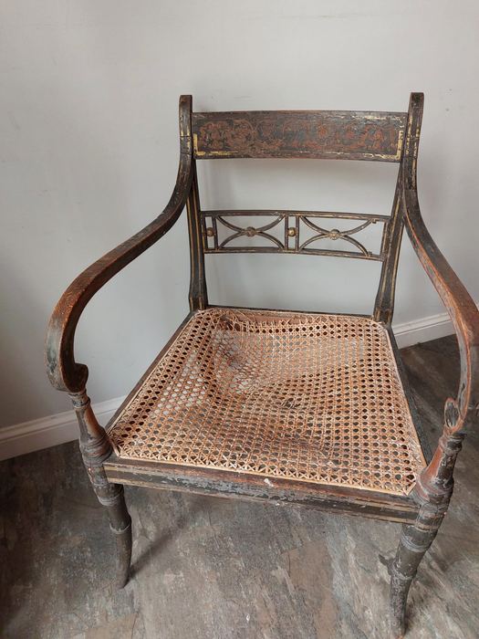 Antique armchair with damaged cane seat, torn and collapsed cane in the back left corner — before cane seat restoration