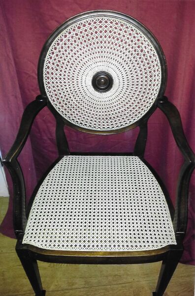 Georgian Hepplewhite-style ebonised armchair with circular medallion caned back in fine sunburst pattern and caned seat