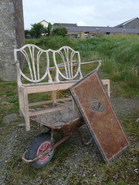 Hepplewhite-style double settee mid-restoration, painted teal with temporary upholstered seat cushion in workshop