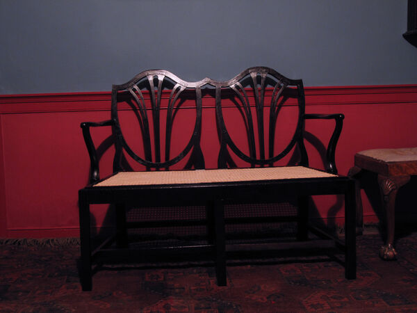 Hepplewhite-style double settee fully restored with ebonised finish and freshly hand-caned seat — completed commission