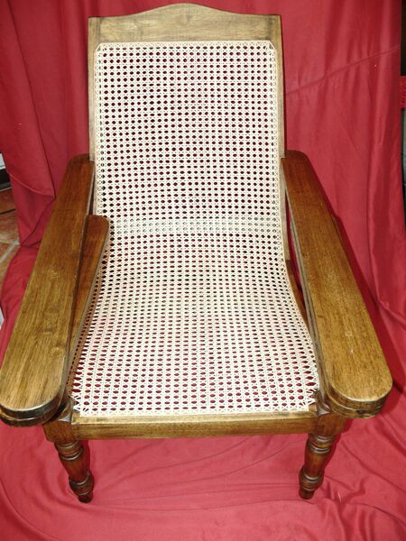 Colonial plantation-style reclining steamer chair with large hand-caned seat and back panel, turned legs — restoration complete