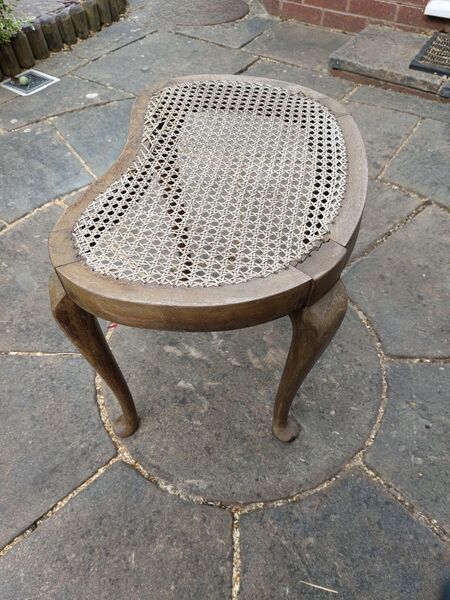 Queen Anne style caned footstool with worn and sagging cane surface — before restoration