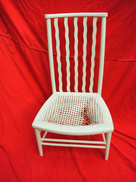 White-painted wavy spindle-back chair with broken and collapsed cane seat — before restoration